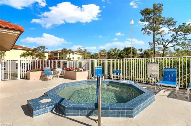 View of swimming pool with a patio and a community hot tub