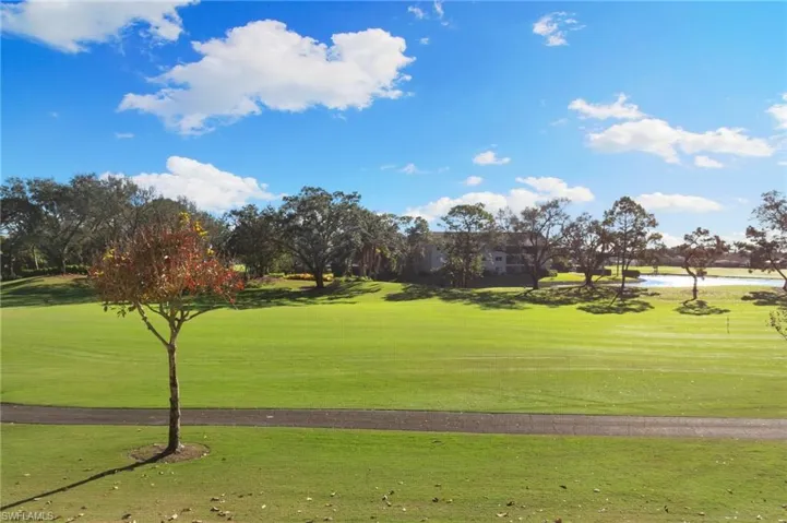 Surrounding community with a water view and a lawn