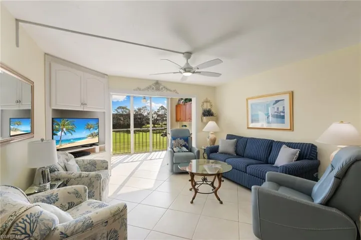 Tiled living room featuring ceiling fan