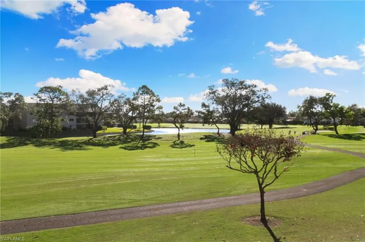 View of property's community featuring a yard and a water view