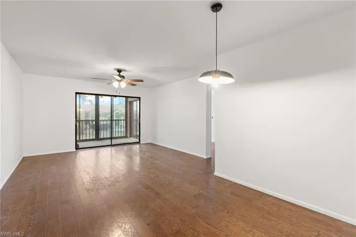 Unfurnished room featuring wood-type flooring and ceiling fan