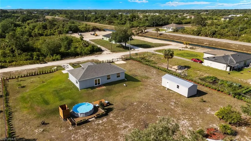Birds eye view of property with a forest view and a rural view