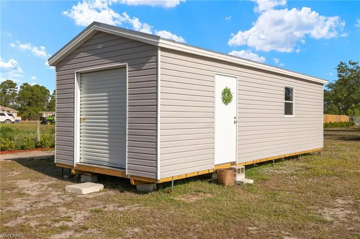 View of outbuilding with an outdoor structure