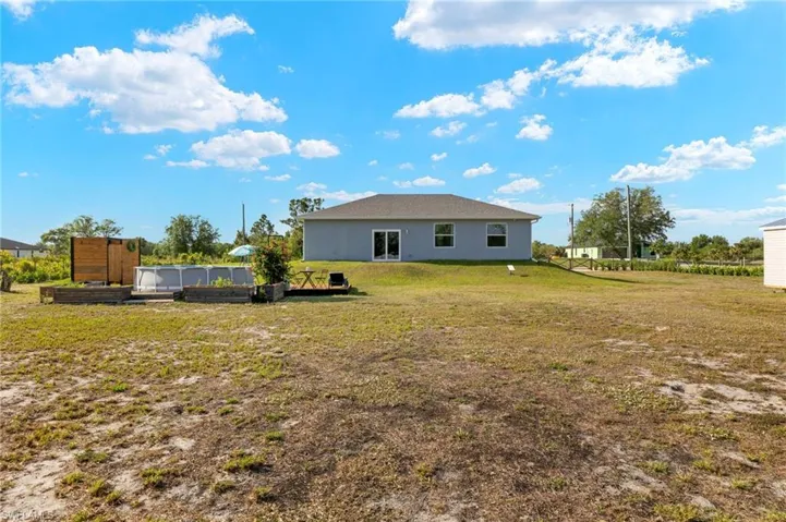 Back of property featuring a lawn