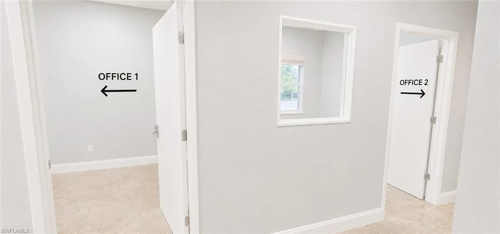 Neutral-toned walls throughout with white baseboards and trim