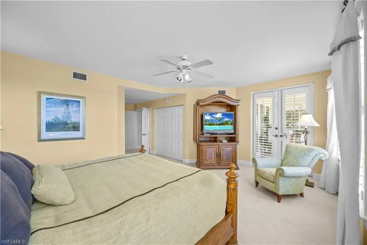 Bedroom with a closet, access to exterior, ceiling fan, carpet, and french doors