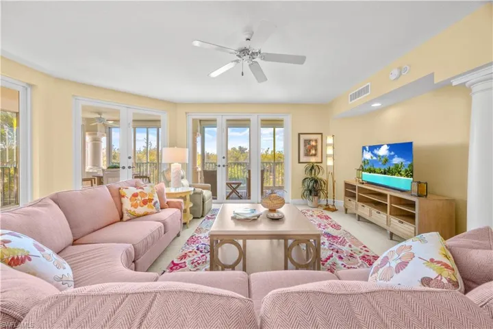 Living area featuring ceiling fan and french doors