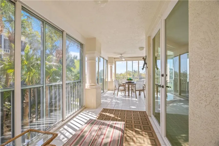 Unfurnished sunroom featuring tile patterned flooring and a textured ceiling