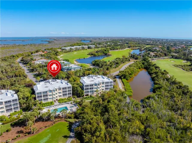 Bird's eye view of a golf course and a nearby body of water