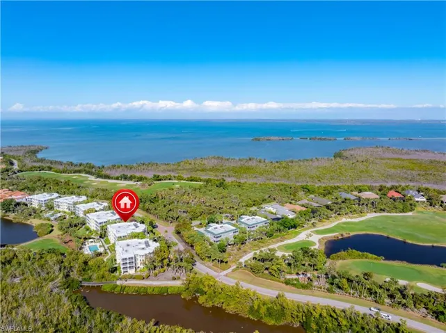 Drone / aerial view of a large body of water and a golf course