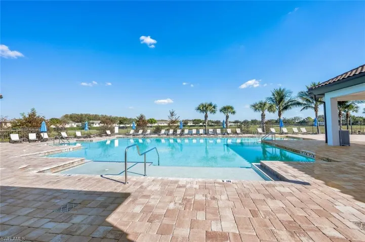 Community pool with a patio