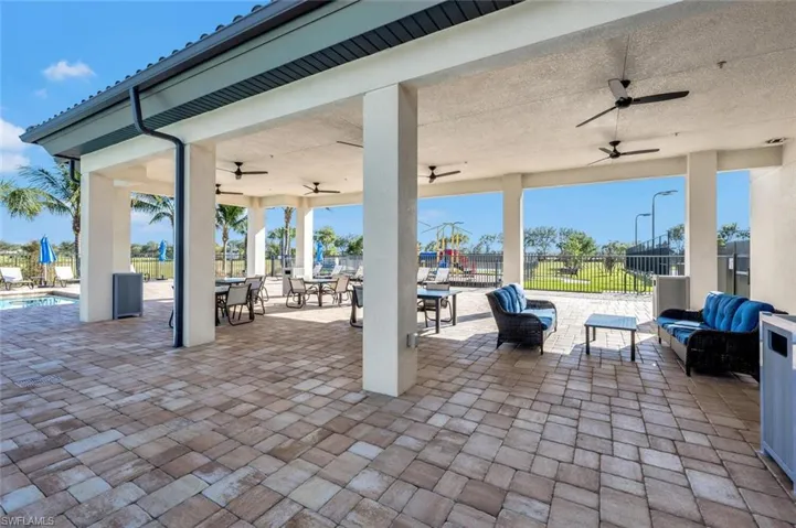 View of patio / terrace with ceiling fan, outdoor lounge area, outdoor dining space, and a community pool