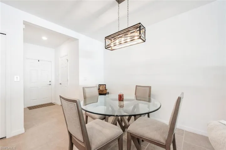 Dining area featuring baseboards and light tile patterned flooring