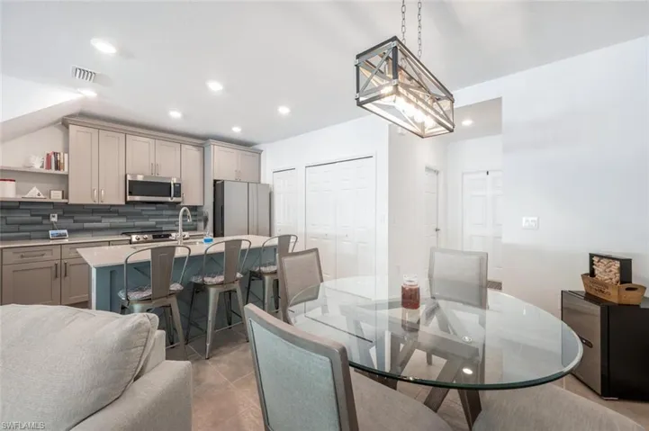 Dining area with recessed lighting and light tile patterned flooring