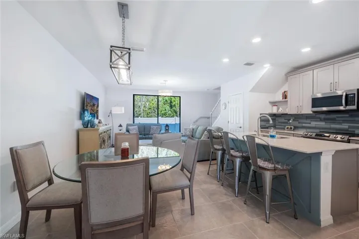 Dining space featuring recessed lighting and light tile patterned flooring