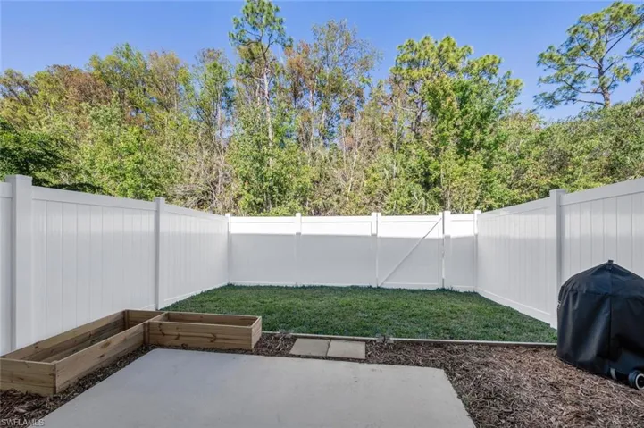 Fenced backyard with a patio area