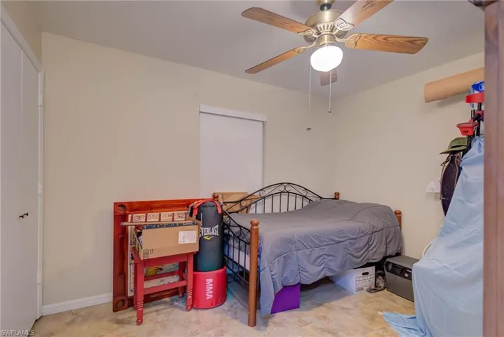 Bedroom with ceiling fan and baseboards