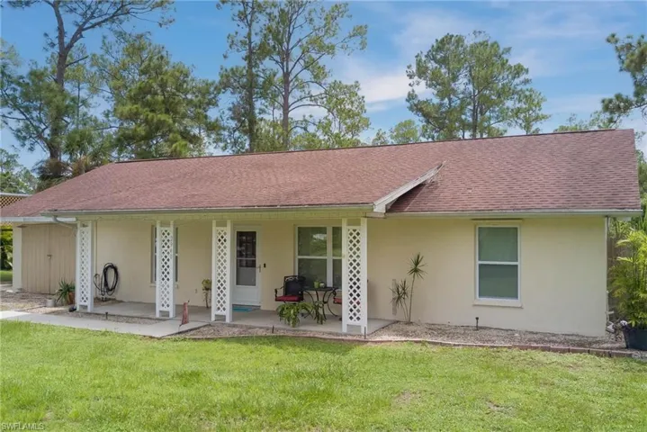 Ranch-style house with a front yard, stucco siding, and roof with shingles