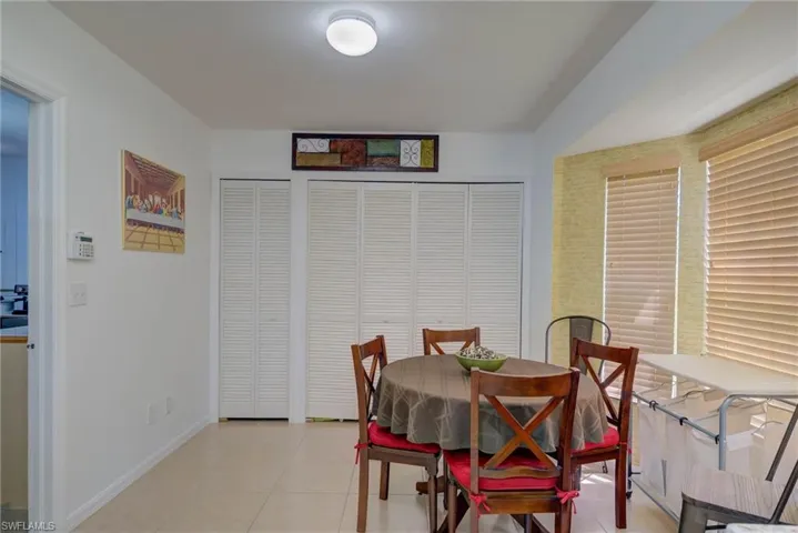 Dining area with baseboards and light tile patterned floors
