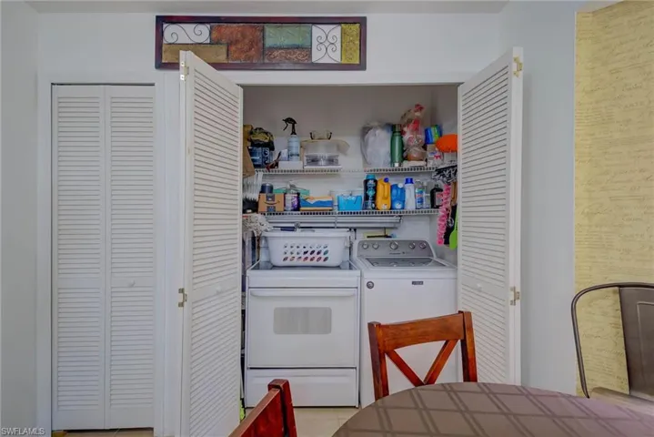 Laundry area with light tile patterned floors and independent washer and dryer