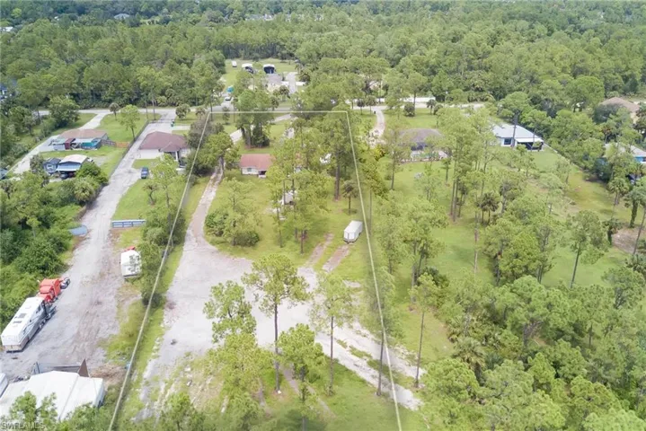 Aerial view of property's location with a forest