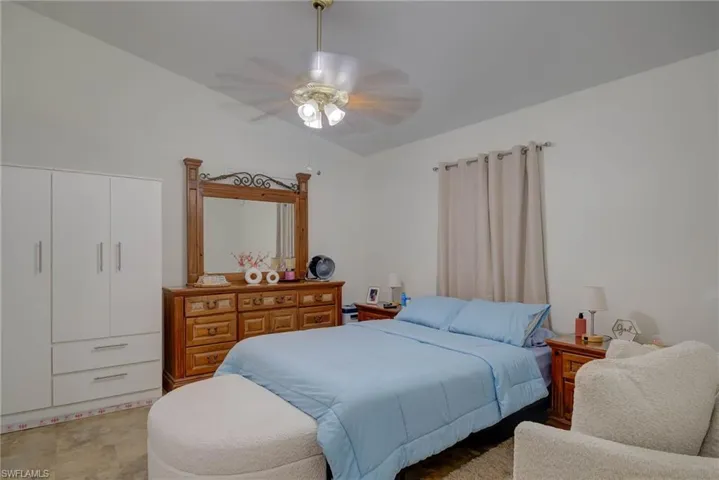 Bedroom with ceiling fan and vaulted ceiling