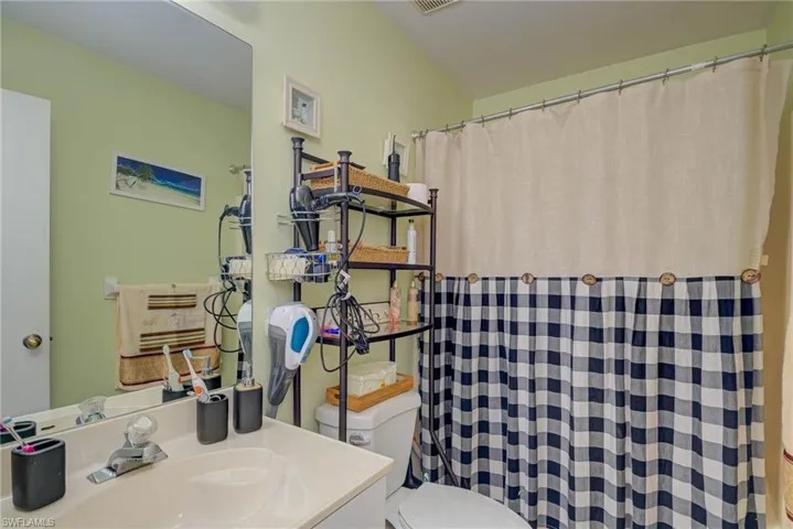 Full bathroom featuring vanity and a shower with shower curtain