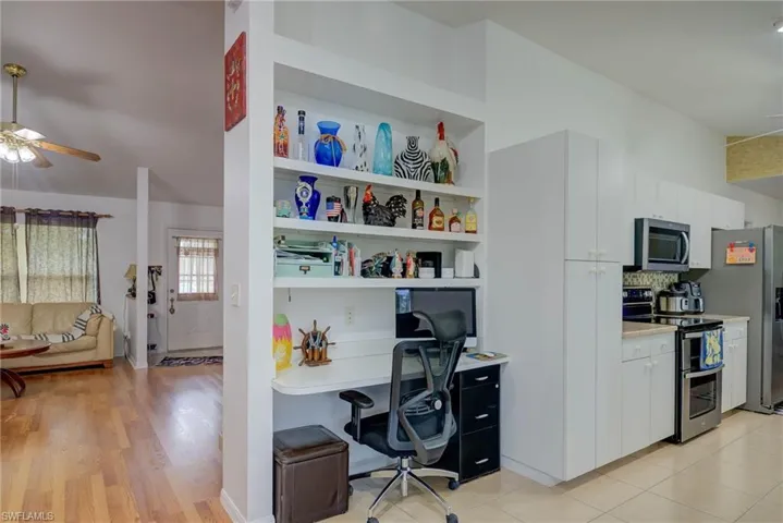 Office area featuring a ceiling fan and built in study area