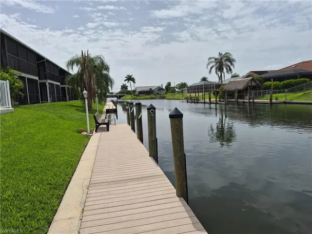 Canal-front property with a private dock featuring multiple pilings