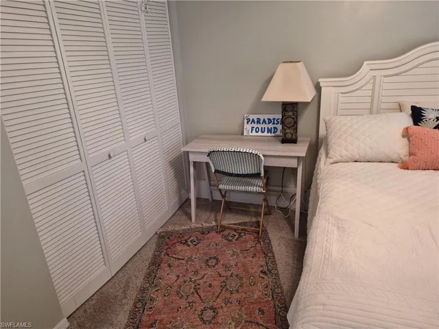 White louvered bi-fold doors provide closet access