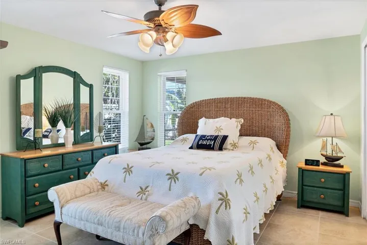 Bedroom with light tile patterned floors and ceiling fan