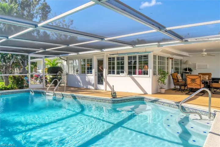 View of swimming pool featuring a lanai and a patio area