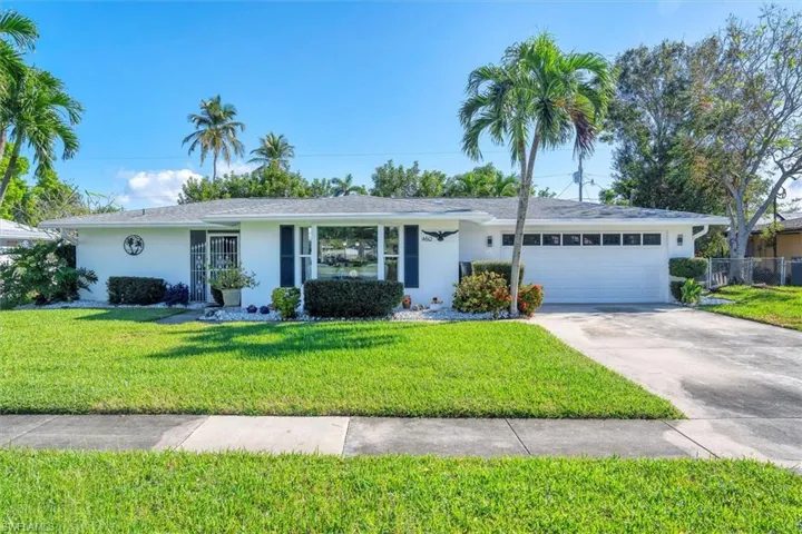 Single story home with a front lawn and a garage