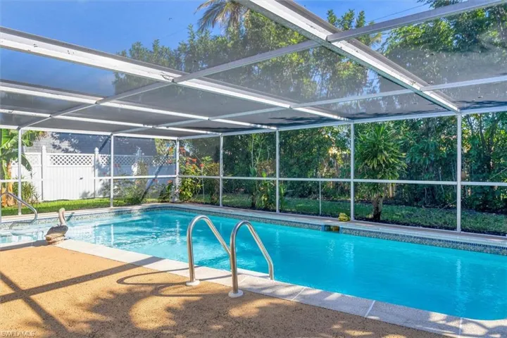 View of pool with a lanai and a patio