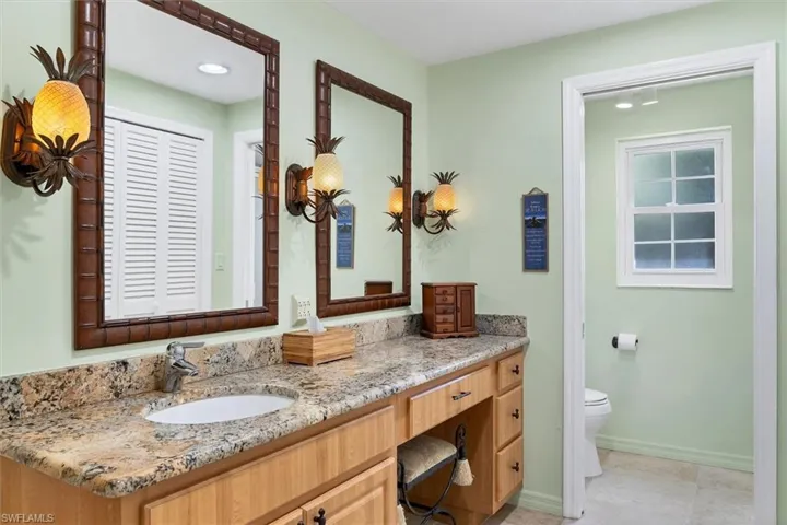 Bathroom featuring tile patterned floors, vanity, and toilet