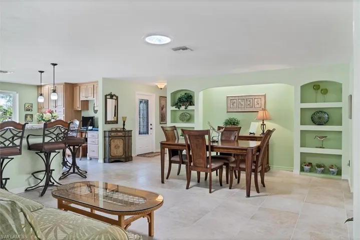 Tiled dining room featuring built in shelves