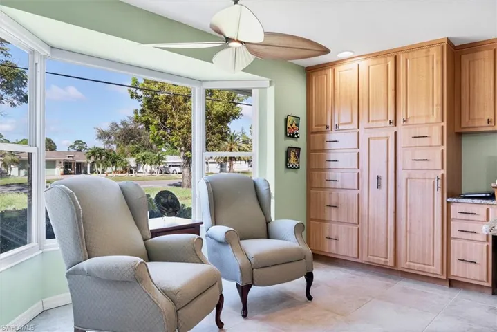 Sitting room featuring ceiling fan and light tile patterned flooring
