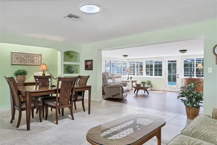 Tiled dining room featuring built in shelves