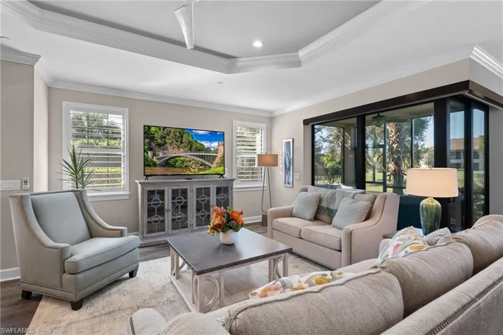 Living room featuring ornamental molding and hardwood / wood-style flooring