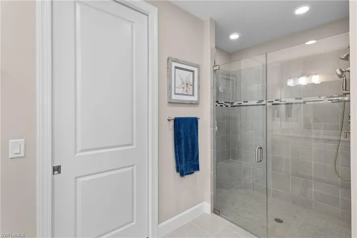 Bathroom with tile patterned flooring and walk in shower