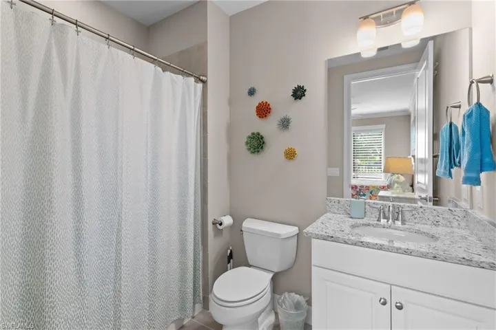 Bathroom with tile patterned floors, vanity, and toilet