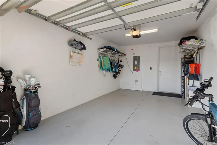 Garage featuring electric panel and a garage door opener