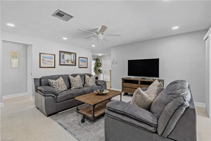 Living room featuring ceiling fan and recessed lighting