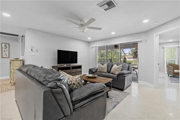 Living room featuring ceiling fan and plenty of natural light