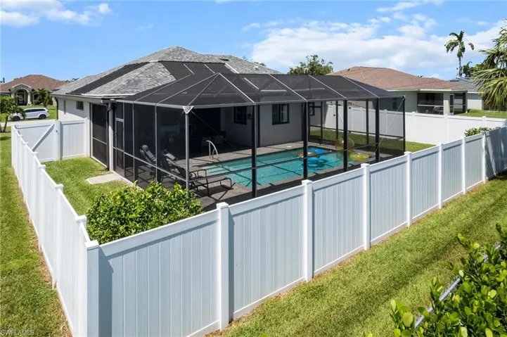 View of pool featuring a fenced backyard, a sunroom, a lanai, and a patio area