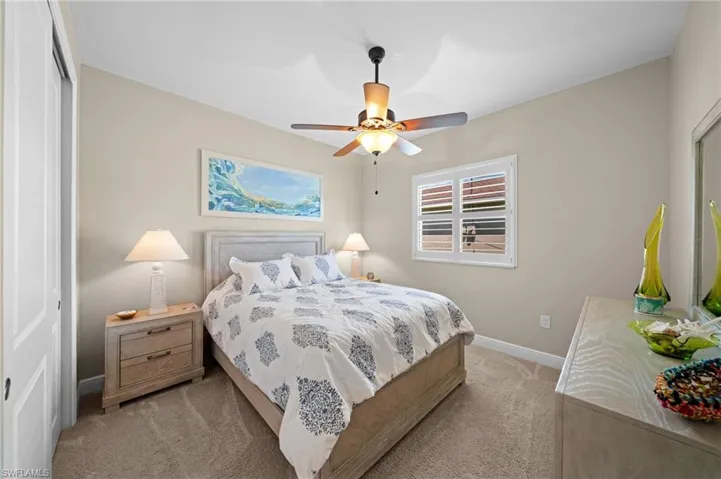 Bedroom with carpet flooring, a closet, and a ceiling fan