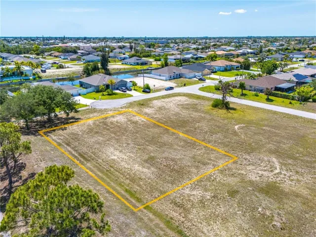 Aerial view of residential area featuring property boundaries highlighted