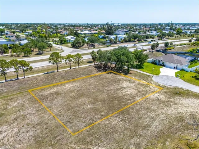 Aerial perspective of suburban area featuring property parcel outlined