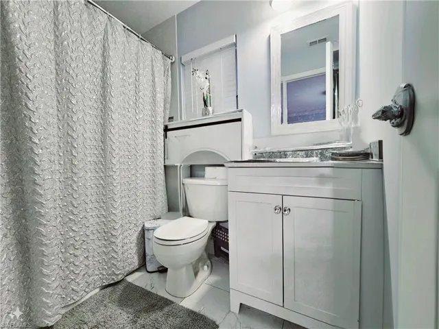 Bathroom with tile patterned floors, vanity, and toilet