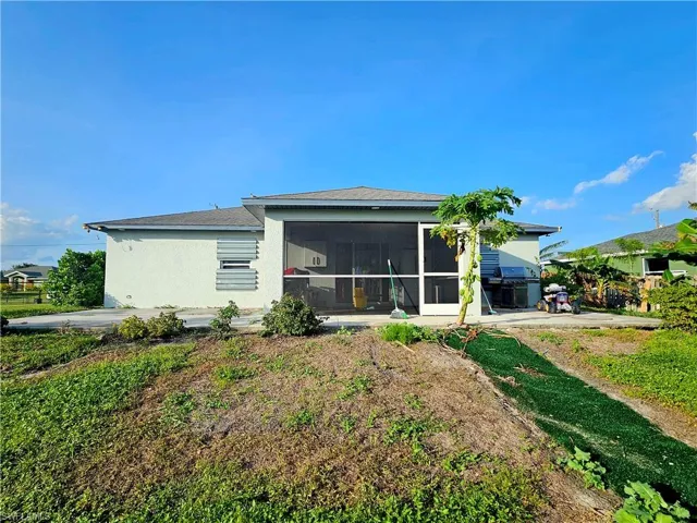Back of property featuring a sunroom
